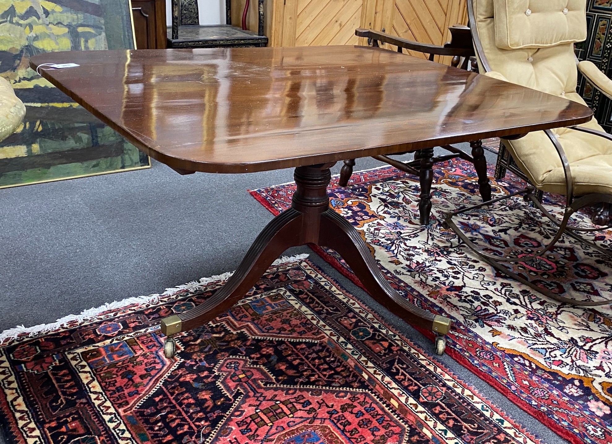 A Regency rectangular mahogany snap top breakfast table on brass casters, width 128cm depth 109cm height 70cm